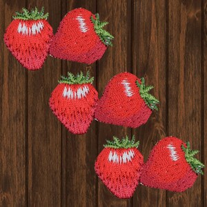 May include: Six embroidered strawberry patches with green leaves and white seeds. The strawberries are a bright red color and are arranged in two rows of three.