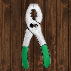 May include: A white and green embroidered patch of a pair of pliers.