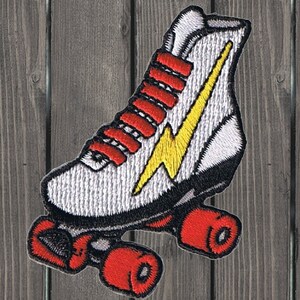 May include: White roller skate with red wheels and a yellow lightning bolt design. The skate has red laces and a white tongue.