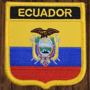 May include: A yellow, blue, and red embroidered patch with the Ecuadorian coat of arms and the word "ECUADOR" in black lettering.