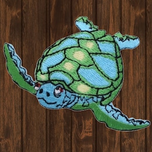 May include: A green and blue embroidered sea turtle patch. The turtle has a detailed shell with a light blue and green pattern.