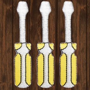 May include: Three yellow and white screwdrivers with black handles. The screwdrivers are arranged vertically against a wood background.