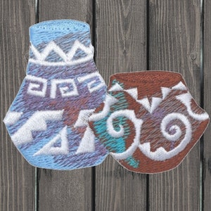 May include: Two embroidered patches depicting stylised pottery in blue and brown with white designs. The blue patch has a geometric pattern and the brown patch has a swirling pattern.