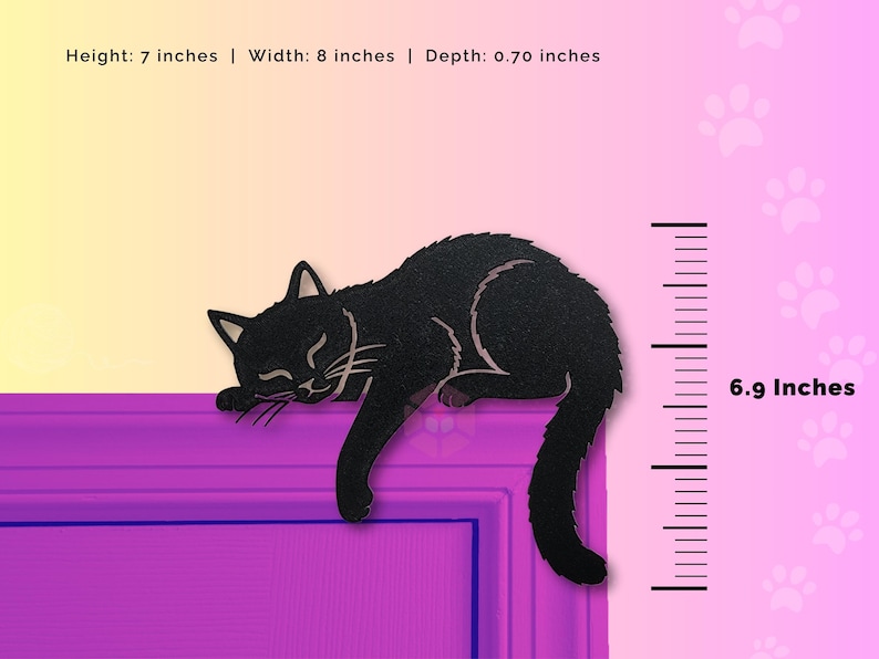 May include: A black cat-shaped decoration, 7 inches high, 8 inches wide, and 0.70 inches deep, is shown resting on a purple surface. The cat is depicted with its eyes closed, suggesting sleep. The background has a gradient of yellow to pink.