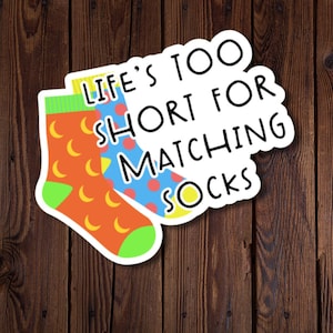 May include: A sticker with two mismatched socks and the text "Life's too short for matching socks".