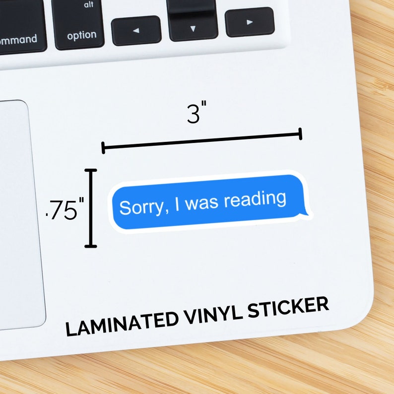 May include: A laminated vinyl sticker with the text "Sorry, I was reading" in a blue speech bubble. The sticker is 3 inches wide and 0.75 inches tall.