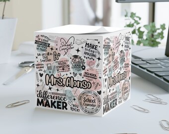 May include: A white square box with a colorful design featuring the words "School Counselor" and "Mrs. Alonso". The box is decorated with stars, hearts, and other school-related imagery. The text "Make today amazing" and "Difference Maker" are also included in the design.