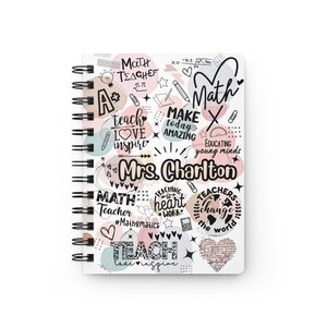 May include: A white spiral notebook with a pink, peach, and blue watercolour design. The notebook has a variety of math-themed doodles and text, including "Math Teacher", "Make Today Amazing", and "Educating Young Minds". The notebook also includes the name "Mrs. Charlton".