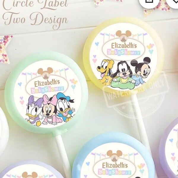 May include: Circular lollipops with Disney character designs, including Mickey Mouse, Minnie Mouse, Donald Duck, and Pluto. Each lollipop features the text "Elizabeth's Baby Shower" and is on a white stick. The lollipops have pastel-colored backgrounds.