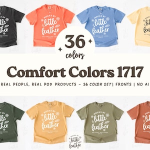 以下が含まれることがあります： 黒、オレンジ、青、黄色など、さまざまな色のComfort Colors 1717 Tシャツのコレクション。各シャツには「mocks by little feather」の文字が入っています。画像には「36 colors」の文字も表示されています。
