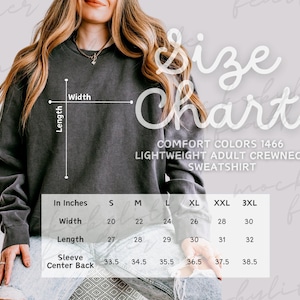 May include: A charcoal gray crewneck sweatshirt with a size chart overlay. The text reads Size Chart, Comfort Colors 1466 Lightweight Adult Crewneck Sweatshirt, and includes a table with width, length, and sleeve center back measurements in inches.