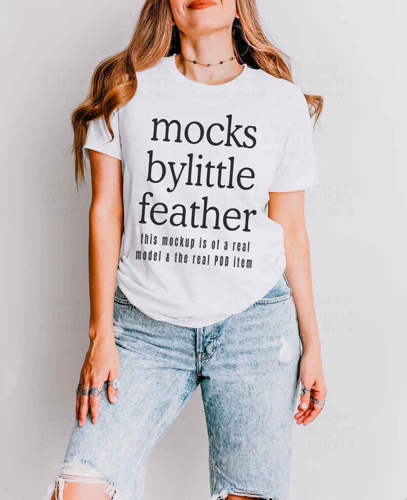 May include: White t-shirt with black text that reads "mocks bylittle feather this mockup is of a real model & the real POD item".
