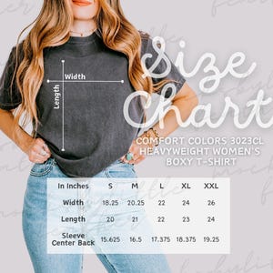 May include: A charcoal grey boxy t-shirt with a size chart overlay. The text reads Size Chart, Comfort Colors 3023CL Heavyweight Women's Boxy T-Shirt, and includes a table with width, length, and sleeve center back measurements in inches for sizes S to XXL.