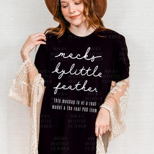 May include: A black mock neck t-shirt with the text "mocks by little feather" and the additional text "this mockup is of a real model & the real POD item".