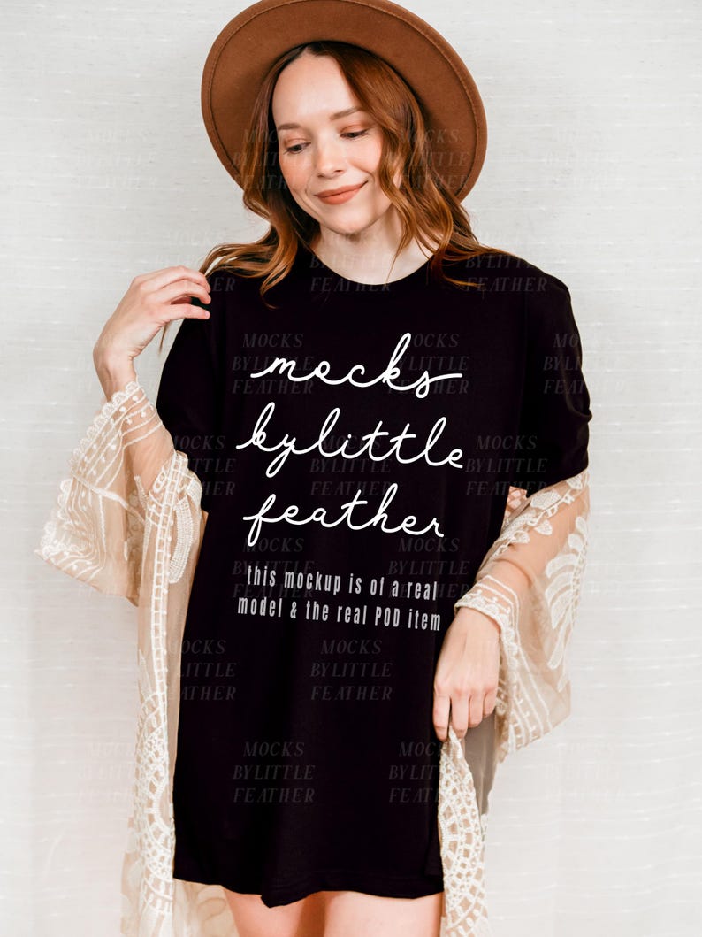 May include: A black mock neck t-shirt with the text "mocks by little feather" and the additional text "this mockup is of a real model & the real POD item".