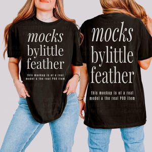 May include: A black short-sleeve t-shirt featuring white serif text that reads mocks bylittle feather and smaller text stating this mockup is of a real model & the real POD item. The shirt is paired with light blue denim jeans.