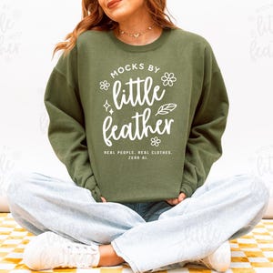 Gildan 18000 Crewneck Sweater Sweatshirt Mockup in the color Military Green featuring a Real Model in a bright Studio setting. Simple and Trendy design ideal for Etsy Print on Demand (POD) sellers. High-quality Mock, Mock-Up created by MocksByLittleFeather. Real Clothes, No AI.