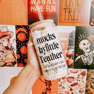 May include: A clear glass tumbler with a bamboo lid and a clear straw, filled with white crinkle paper. The glass features the black text 'mocks bylittle feather' and 'this mockup is of a real model & the real POD item' printed on the front surface.