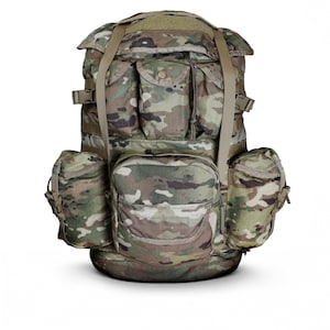 May include: A large tactical backpack featuring a multi-colour camouflage pattern in shades of green, brown, and tan. The pack includes a main compartment with a top flap, two upper pockets, a large central lower pocket, and two side pockets.