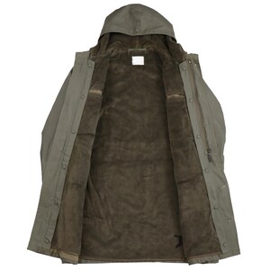 Puede incluir: Una chaqueta verde con capucha y forro de borreguillo marr&oacute;n. La chaqueta est&aacute; abierta y el forro es visible. La chaqueta tiene cierre de botones y capucha con cord&oacute;n.