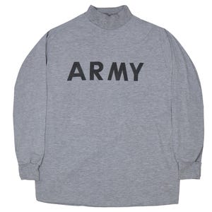 May include: A gray long-sleeved shirt with a mock turtleneck collar. The word "ARMY" is printed in bold black letters across the chest. The shirt has long sleeves and a relaxed fit.