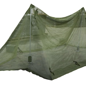 May include: A green mosquito net tent, designed to protect against insects. The tent is supported by poles and has a triangular shape. The fabric is translucent, allowing visibility while providing a barrier.