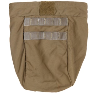 May include: A tan-colored fabric dump pouch featuring a rectangular hook-and-loop fastener strip at the top center and two horizontal rows of webbing straps on the front surface, designed for attachment to gear or belts with a wide opening.