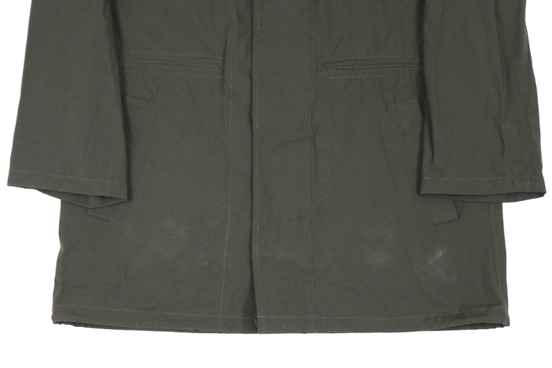 May include: A dark green utility jacket with a button closure and two pockets on each side.