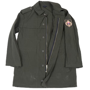 May include: A dark green military-style jacket with a zipper and button closure. The jacket has a patch on the right shoulder with a gold emblem.