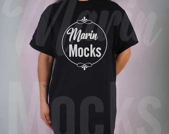 May include: A black oversized t-shirt with a white circle design that says "Marin Mocks" in a script font.