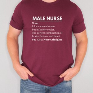 Puede incluir: Una camiseta de color granate con texto blanco que dice "MALE NURSE Noun Like a normal nurse but infinitely cooler. The perfect combination of brains, brawn, and heart. See Also: Nurse Almighty"