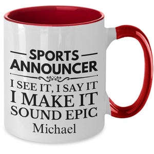 May include: White ceramic coffee mug with a red rim and handle. The mug has black text that reads "Sports Announcer I see it, I say it I make it sound epic Michael".