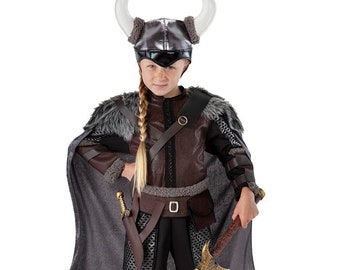May include: A child's Viking costume with a brown leather tunic, grey cape, and a horned helmet. The costume includes a sword and an axe.