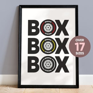 May include: Black and white print of the word "BOX" repeated three times with a stylized tire design in red, yellow, and gray in the center of each word. The text "OVER 17 SIZES" is in a pink circle in the upper right corner.