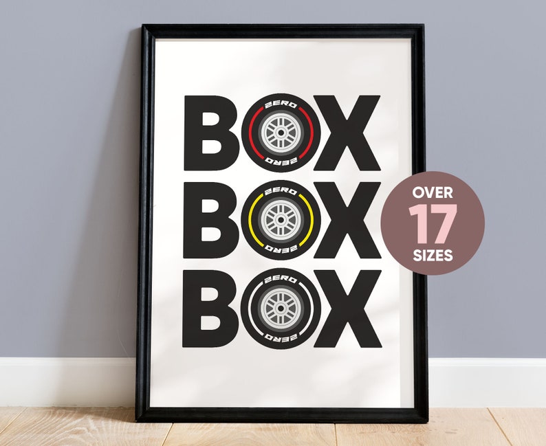 May include: Black and white print of the word "BOX" repeated three times with a stylized tire design in red, yellow, and gray in the center of each word. The text "OVER 17 SIZES" is in a pink circle in the upper right corner.