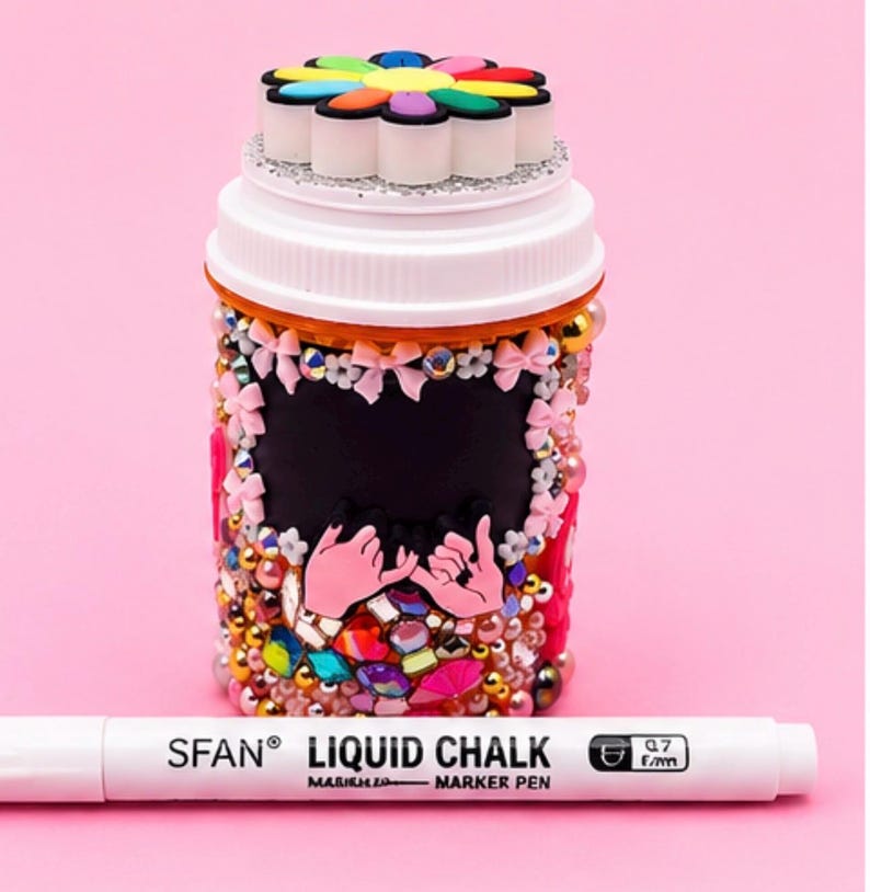 Breast cancer awareness pill bottle with pink rhinestones, bows, and a chalkboard label