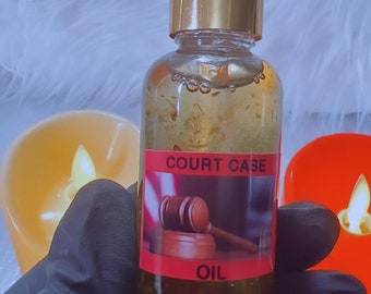 May include: A clear glass bottle with a gold cap and white dropper, filled with a golden liquid and gold flakes. A red label reads "COURT CASE OIL" with a gavel illustration. The bottle is held by a gloved hand.