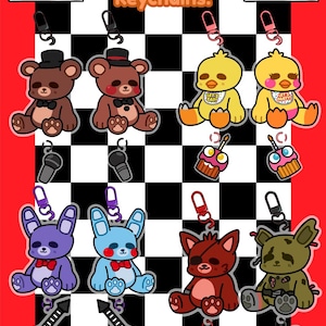 May include: Acrylic linked keychains featuring cartoon characters. The keychains include a brown bear, yellow chick, purple bunny, blue bunny, red fox, and green bear. Each keychain has a metal clasp and accessory. The text "Acrylic Linked Keychains!" is displayed.