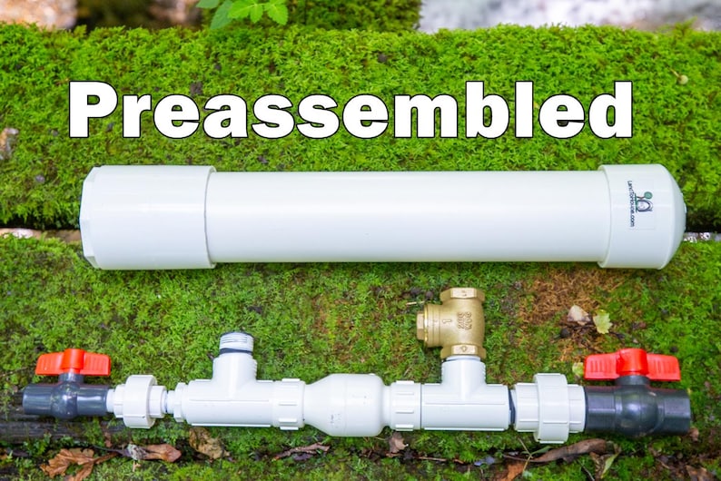 May include: A preassembled white PVC pipe and plumbing components are displayed against a backdrop of green moss. The components include valves, connectors, and a brass fitting, suggesting a DIY or home improvement theme.