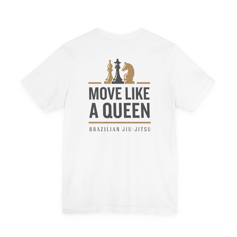 May include: A white short-sleeve t-shirt featuring a graphic on the back. The design includes three chess pieces in gold and black, with the text MOVE LIKE A QUEEN in bold black letters and BRAZILIAN JIU-JITSU in smaller black text below.