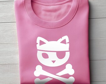 May include: Pink sweatshirt with a white pirate cat graphic. The graphic features a cat face wearing an eye patch and a bandana, with crossed bones below. The sweatshirt is folded neatly on a light wood-grain surface.