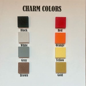 May include: Charm colors chart with squares of black, white, gray, brown, red, orange, yellow, and gold.
