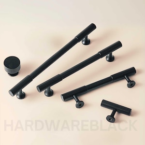 May include: Four black metal cabinet pulls with a ridged design. The pulls are in various sizes and shapes, including a small round knob.
