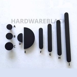 May include: Assortment of black cabinet hardware pulls in various shapes and sizes, including round, half-round, and rectangular.  The pulls are labelled A through I.