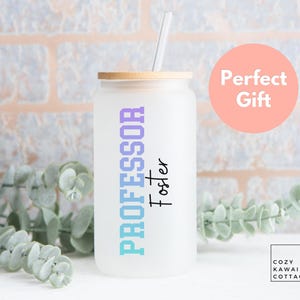 May include: A frosted glass tumbler with a bamboo lid and a white straw. The glass features the text PROFESSOR in vertical purple and blue block letters, followed by the name Foster in black script. A pink circle with white text reads Perfect Gift.