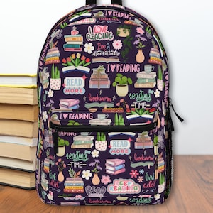 May include: Purple backpack with a colorful pattern of books, plants, and text that says "I love reading", "Read more", "Bookworm", and "Reading time".