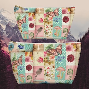 May include: Two pink and blue patchwork cosmetic bags with butterfly, mushroom, and floral designs.