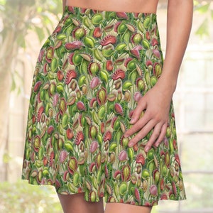 May include: A green and red skirt with a pattern of carnivorous plants. The skirt is made of a soft, stretchy fabric and has a comfortable fit.