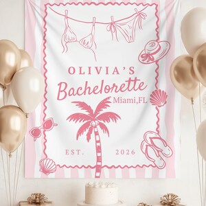 May include: A pink and white striped banner with the text "OLIVIA'S Bachelorette Miami, FL EST. 2026". The banner features illustrations of a bikini, hat, sunglasses, seashells, palm tree, and flip-flops. Balloons and gifts are in the foreground.