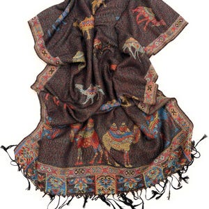 May include: A dark brown scarf with a camel pattern and a decorative border. The scarf features colorful camels in red, blue, and yellow. The border has an intricate design with tassels at the ends.